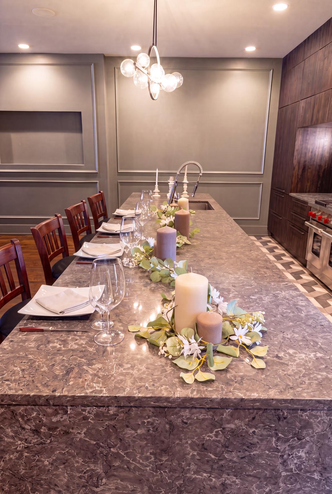 The stone chef's counter beside the kitchen, set for an intimate dinner